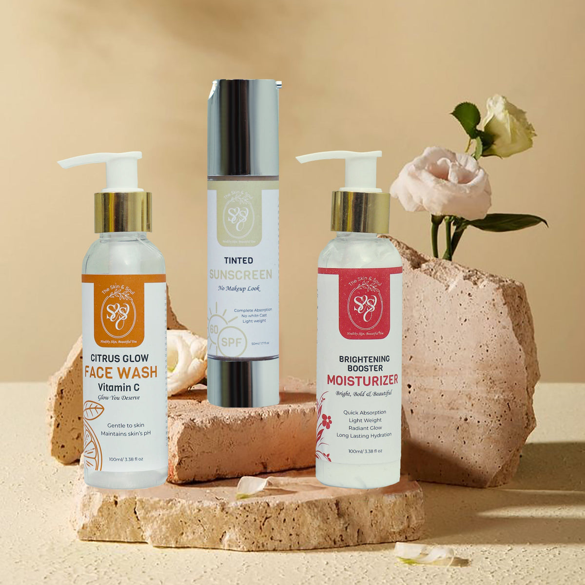 Three skincare products on a natural stone surface with a beige background